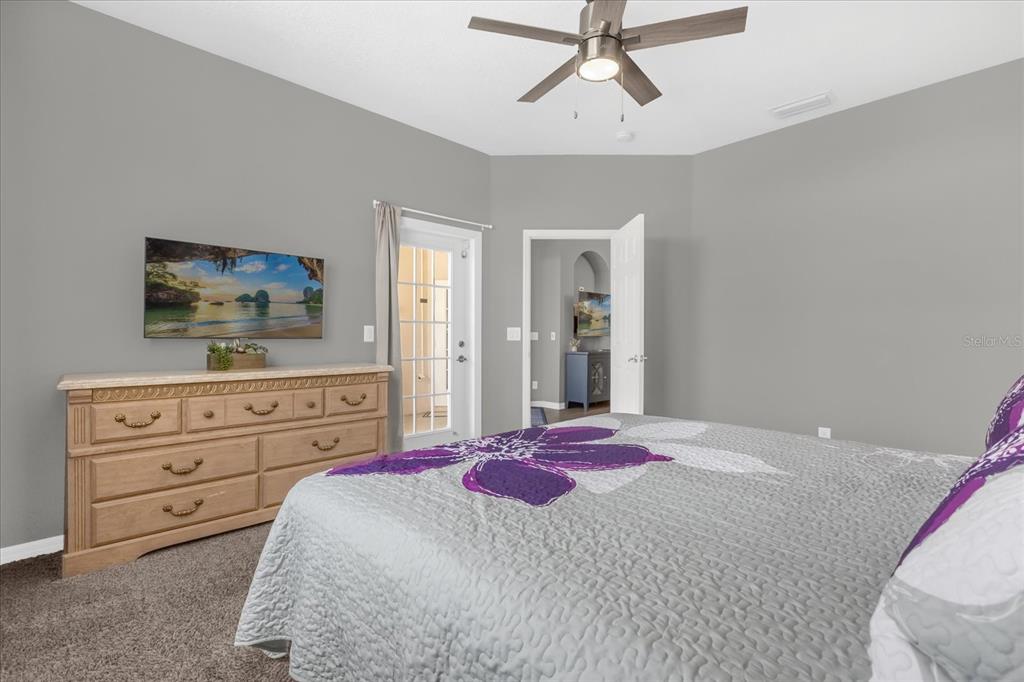 246 Montara Drive Davenport, FL 33897 - Photo 20 of 37 a bedroom with a bed a flat screen tv and a dresser