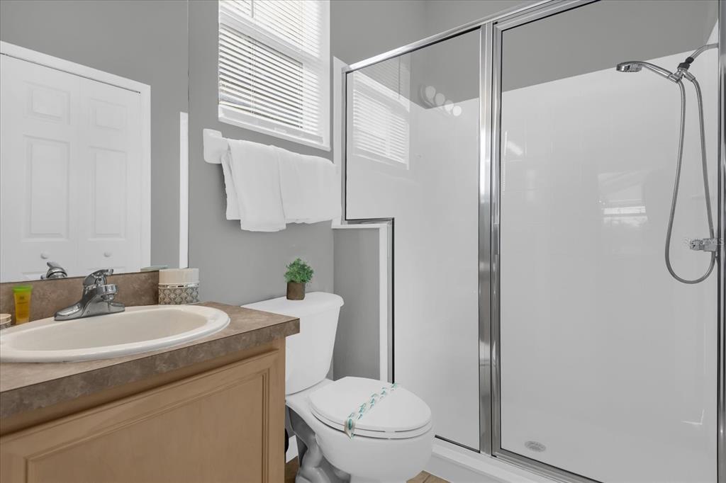 246 Montara Drive Davenport, FL 33897 - Photo 25 of 37 a bathroom with a granite countertop sink toilet and shower