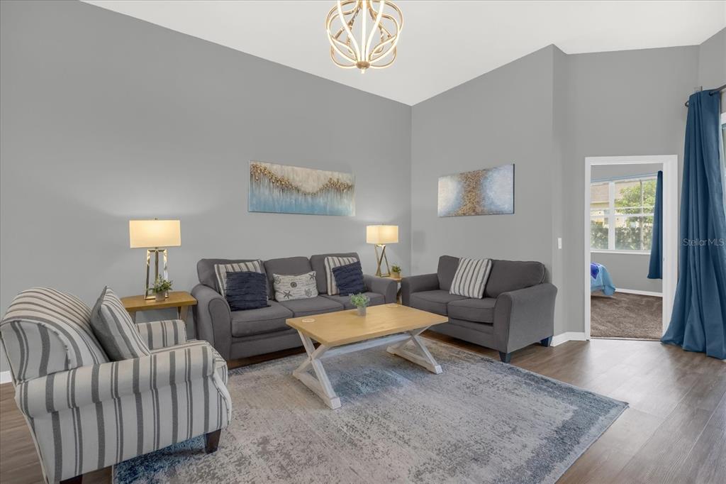 246 Montara Drive Davenport, FL 33897 - Photo 6 of 37 a living room with furniture and a wooden floor