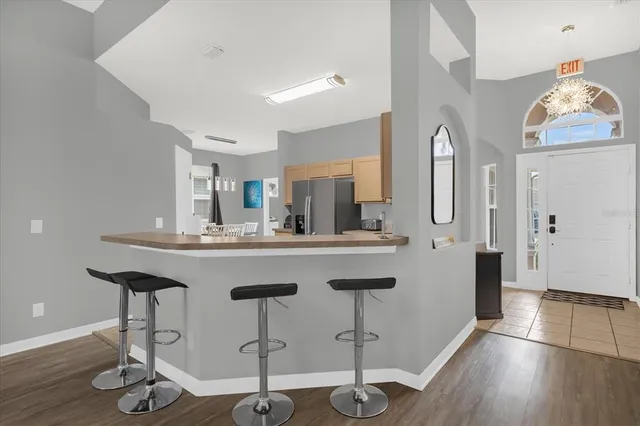 a kitchen with stainless steel appliances granite countertop a sink cabinets and wooden floor