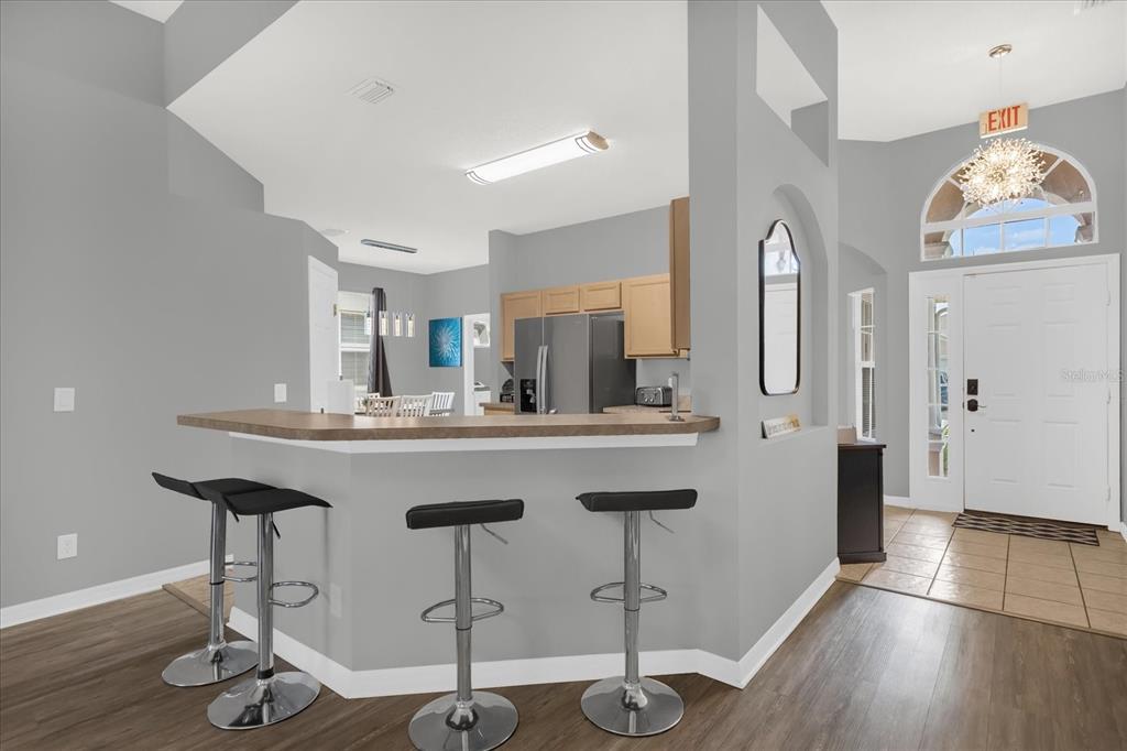 246 Montara Drive Davenport, FL 33897 - Photo 9 of 37 a kitchen with stainless steel appliances granite countertop a sink cabinets and wooden floor