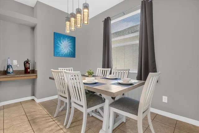 a dining room with furniture and window