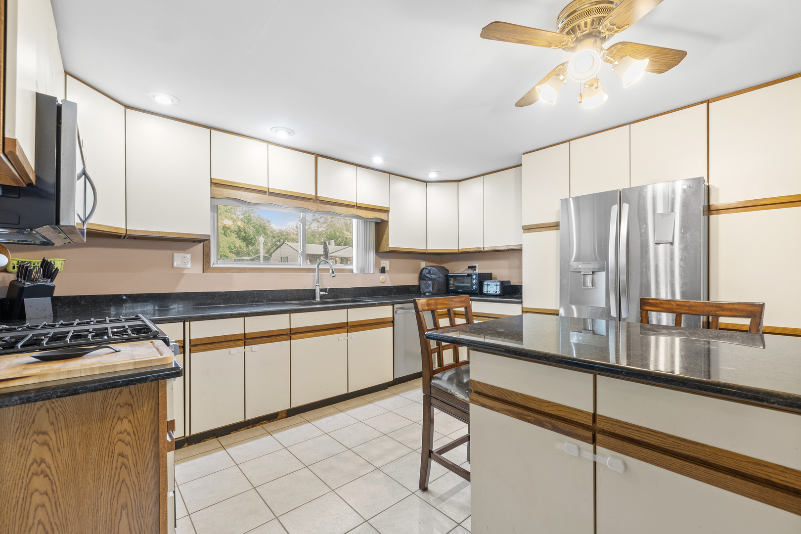 4 Saugatuck Road Montgomery, IL 60538 - Photo 6 of 24 a kitchen with stainless steel appliances kitchen island granite countertop a sink a stove and cabinets