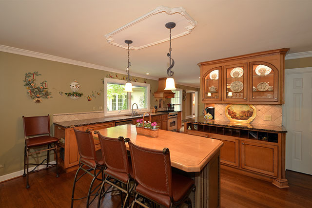 833 North Inverway Road Inverness, IL 60067 - Photo 6 of 25 a dining room with wooden floor a chandelier a wooden table and chairs