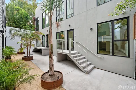 a building outdoor space with patio furniture and potted plants