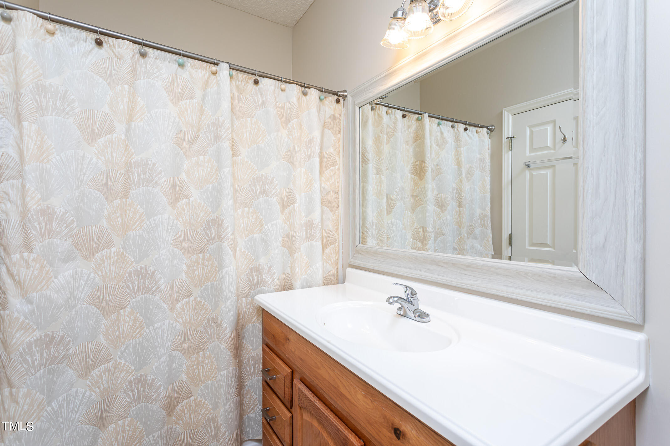 2548 Bent Green Street Raleigh, NC 27614 - Photo 20 of 28 a bathroom with a sink and a mirror