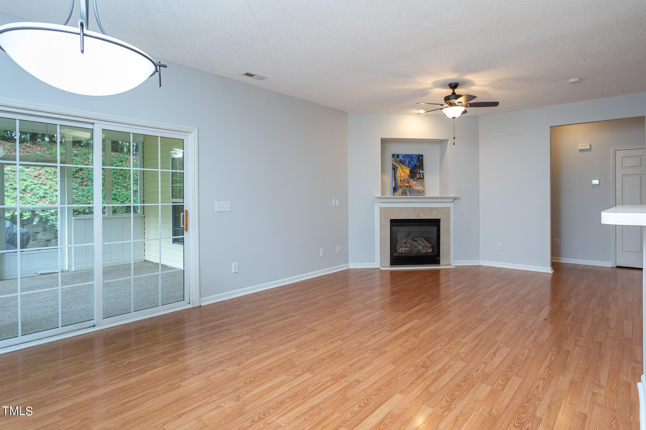 2548 Bent Green Street Raleigh, NC 27614 - Photo 9 of 28 a view of an empty room with a fireplace and a window
