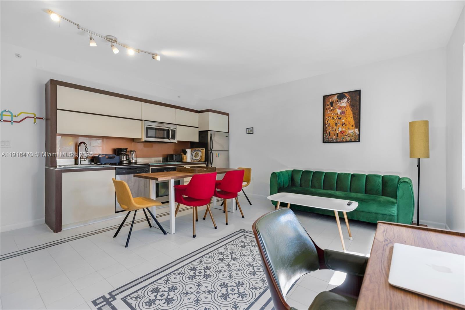 435 21st Street, Unit 311 Miami Beach, FL 33139 - Photo 18 of 40 a living room with furniture a rug and kitchen view