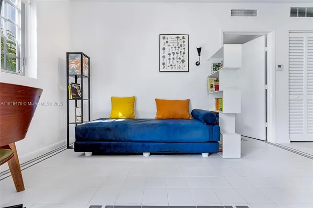 a room with a bed and painting on the wall