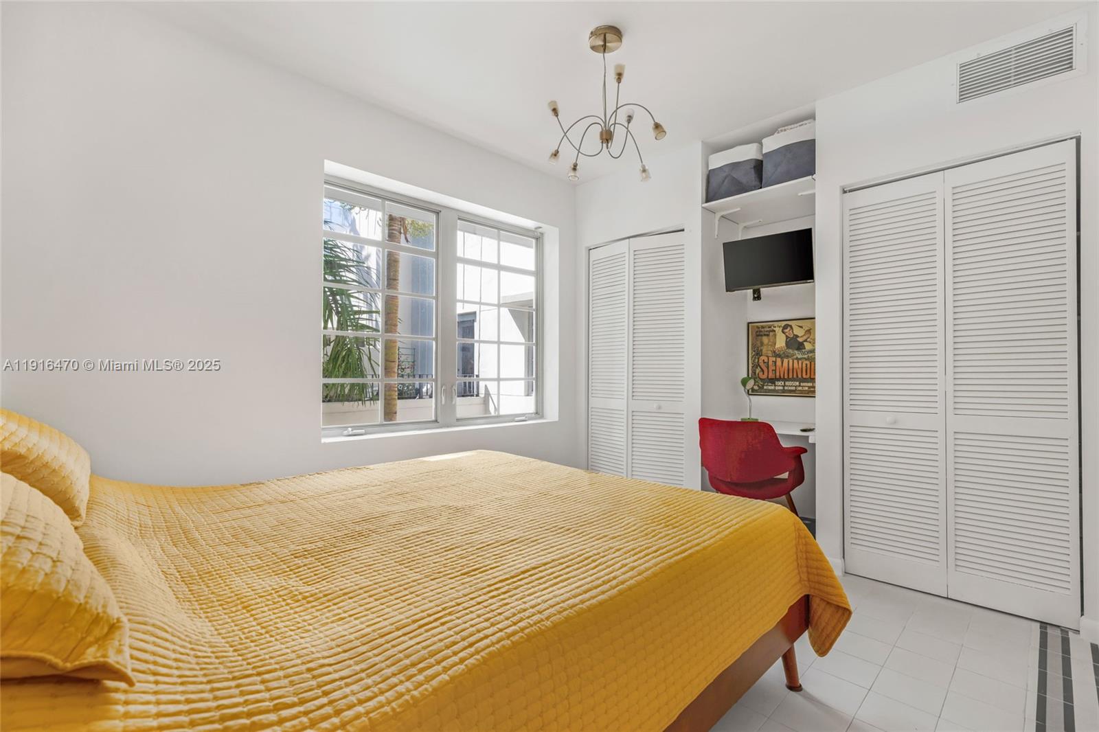 435 21st Street, Unit 311 Miami Beach, FL 33139 - Photo 26 of 40 a bedroom with a bed and a window