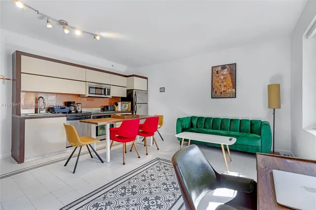 a living room with furniture and a kitchen view