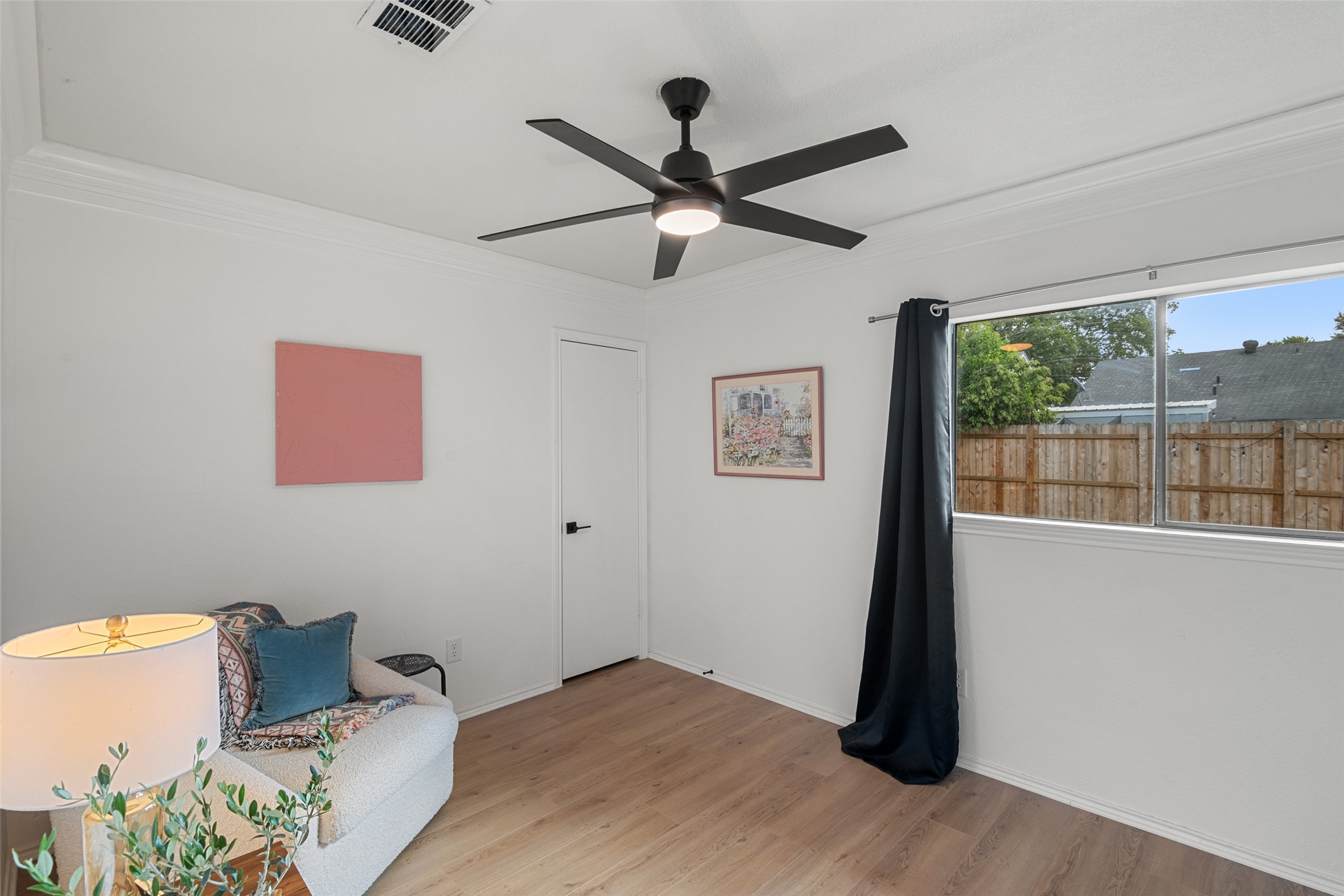 9833 Briar Ridge Drive Austin, TX 78748 - Photo 21 of 29 Living area with light wood finished floors, crown molding, and a ceiling fan