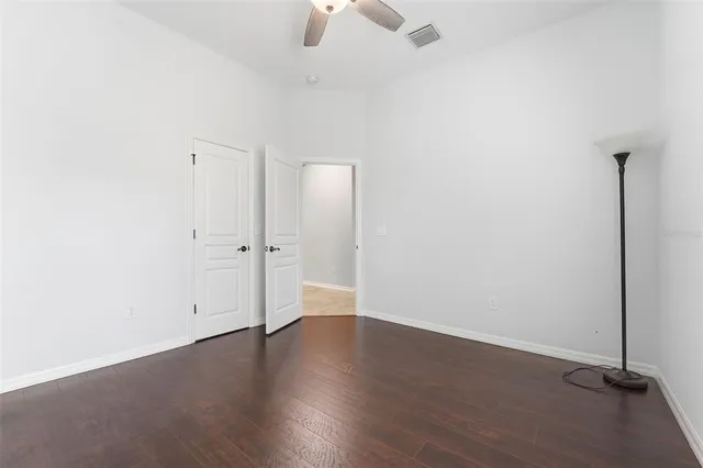 an empty room with wooden floor and window