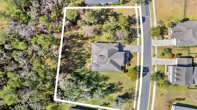 an aerial view of a house with a yard