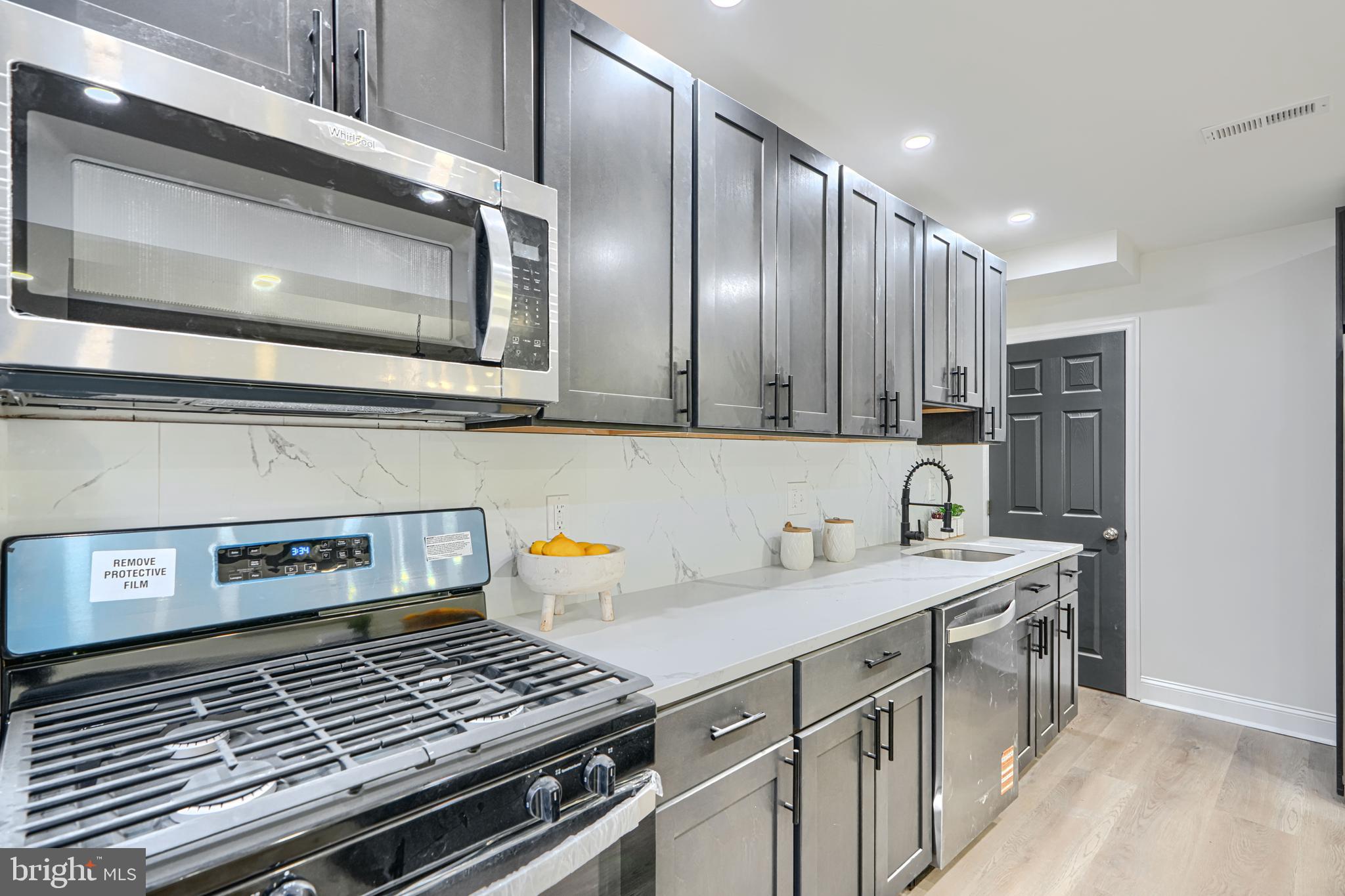 718 Benninghaus Road Baltimore, MD 21212 - Photo 15 of 40 a kitchen with a stove and a microwave