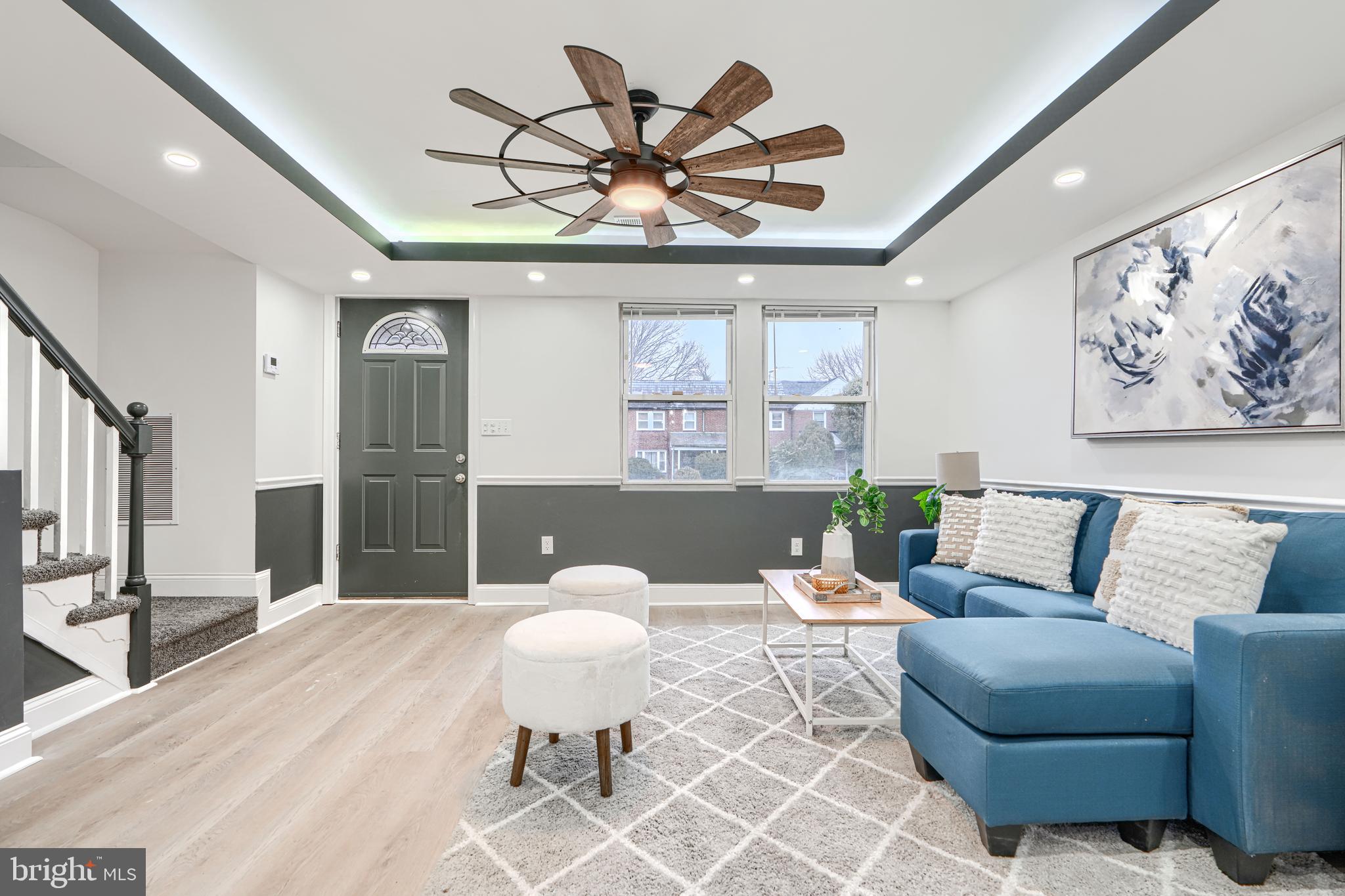 718 Benninghaus Road Baltimore, MD 21212 - Photo 6 of 40 a living room with furniture a chandelier and a large window