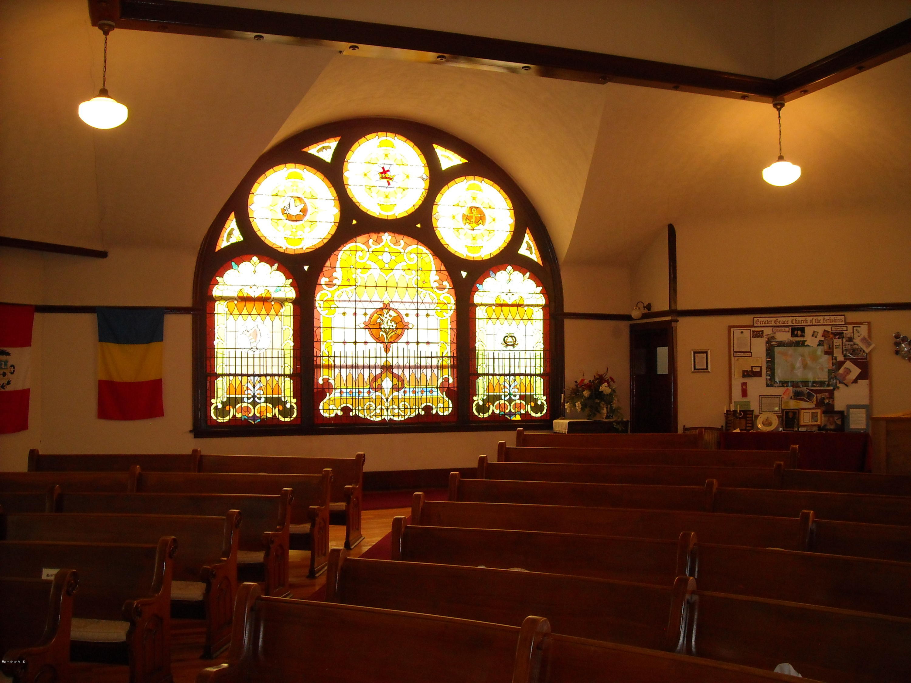 160 High Street Lee, MA 01238 - Photo 3 of 16 a room with lots of trees and a wooden floor