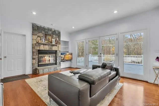 a living room with furniture and a kitchen view