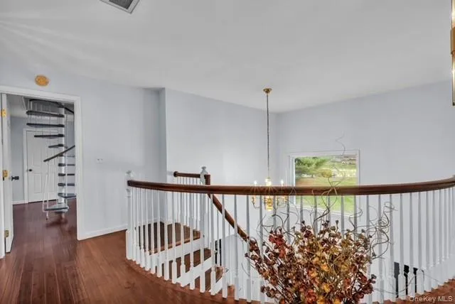 a view of entryway and hall with wooden floor