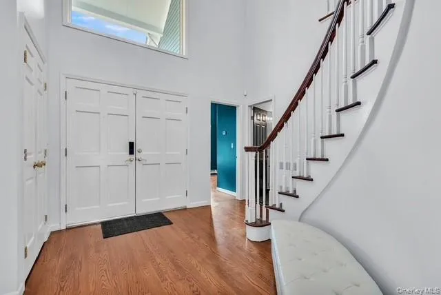 a view of entryway with wooden floor and stairs