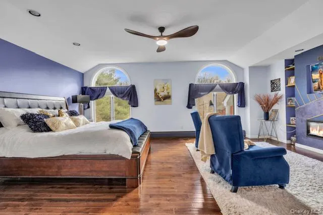 a bathroom with double vanity sinks a toilet and a large mirror