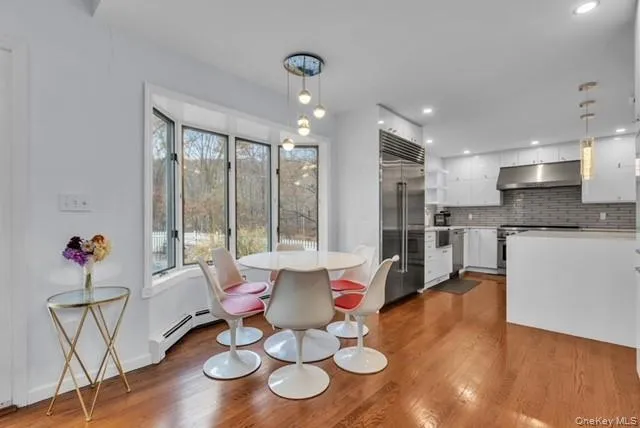 a large kitchen with stainless steel appliances granite countertop a stove a sink and a refrigerator