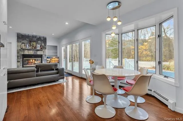 a dining room with furniture a chandelier and wooden floor