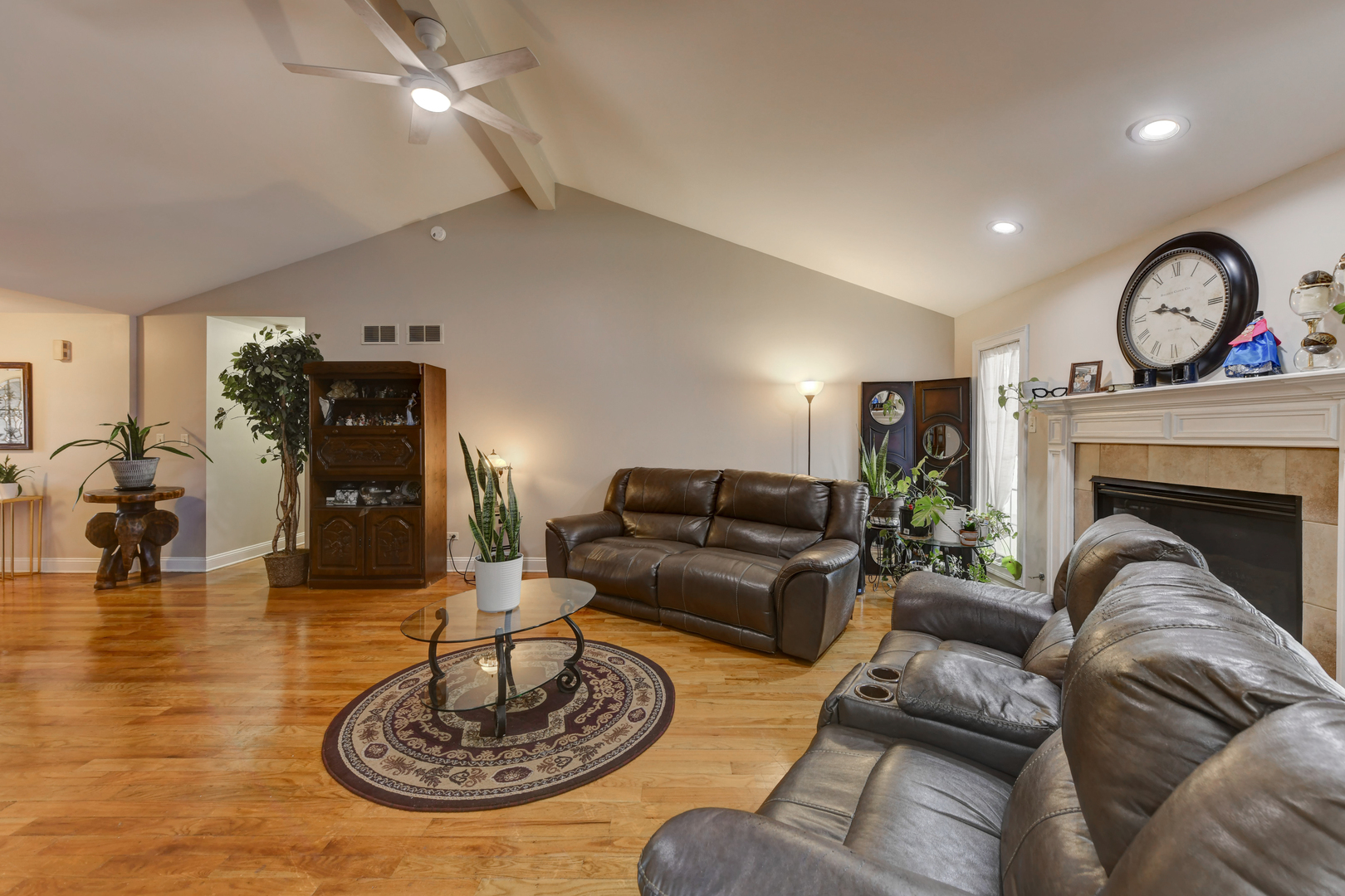 4999 Hawk Lane Monee, IL 60449 - Photo 5 of 20 a living room with furniture a fireplace and a chandelier