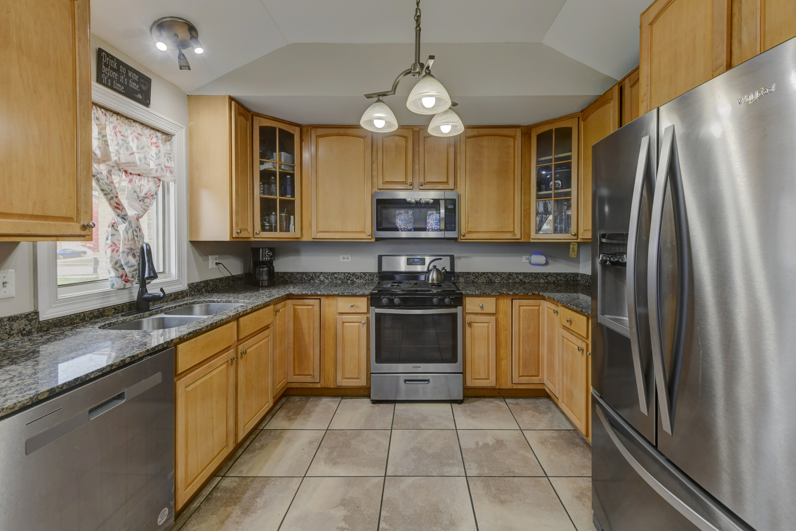 4999 Hawk Lane Monee, IL 60449 - Photo 6 of 20 a kitchen with stainless steel appliances granite countertop a stove a sink and a refrigerator