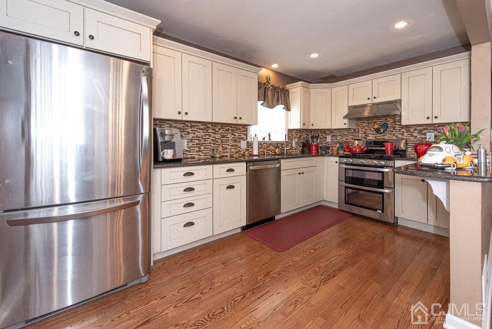 18 Richard Road East Brunswick, NJ 08816 - Photo 19 of 40 a kitchen with stainless steel appliances a refrigerator sink and cabinets