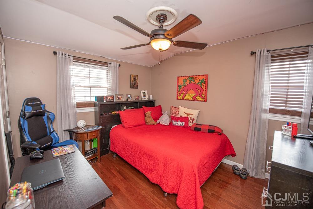 18 Richard Road East Brunswick, NJ 08816 - Photo 27 of 40 a bedroom with a bed and a chandelier