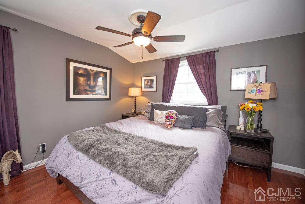 18 Richard Road East Brunswick, NJ 08816 - Photo 30 of 40 a bedroom with a bed and a chandelier