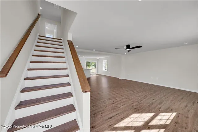 a view of entryway with wooden floor and stairs