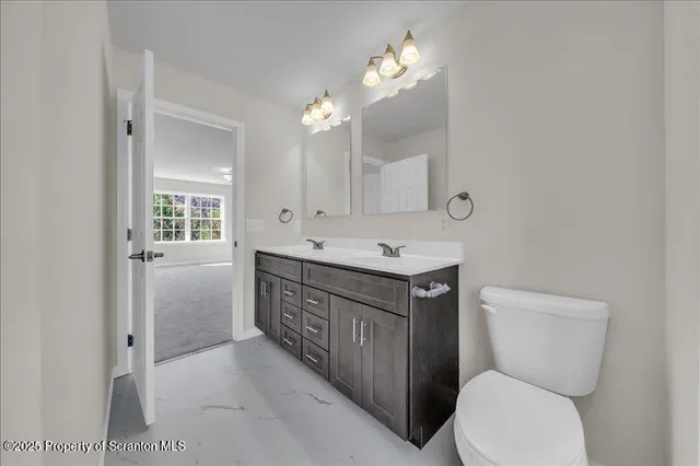 a bathroom with a toilet sink and mirror