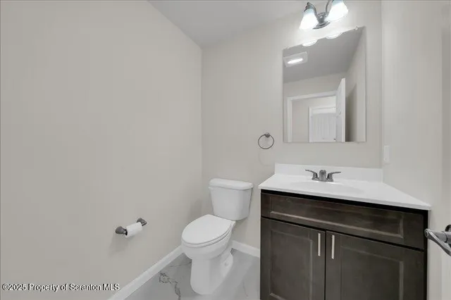 a bathroom with a sink toilet and a mirror