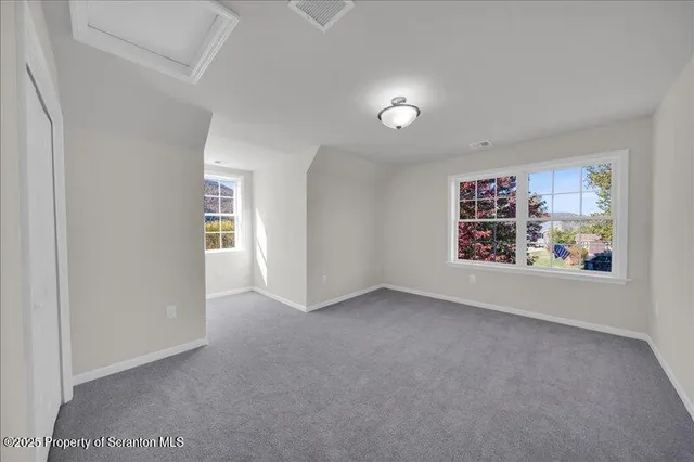 an empty room with painting and furniture