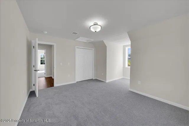 a view of an empty room with exposed radiator