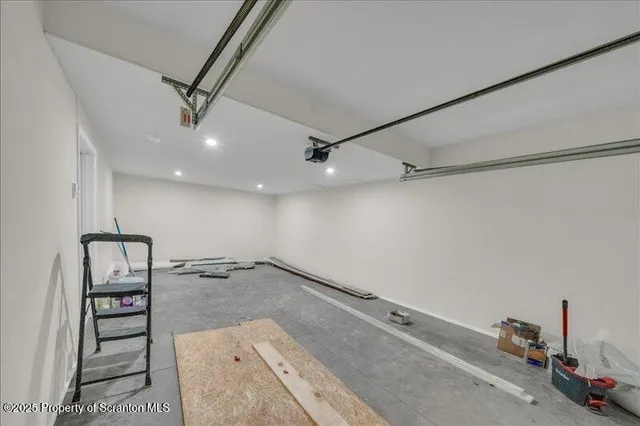 an empty room with wooden floor and ceiling fan