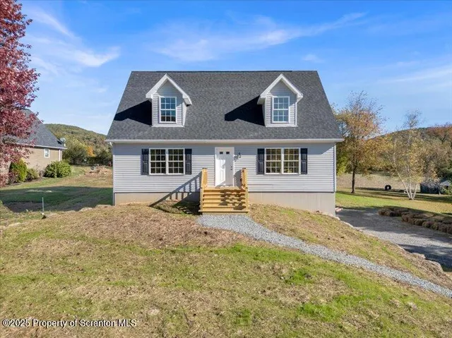 a view of a house with swimming pool and sitting area