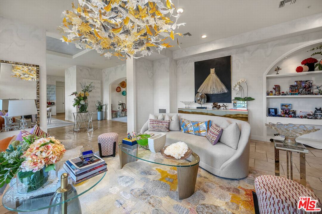 3110 Benedict Canyon Drive Beverly Hills, CA 90210 - Photo 11 of 70 a living room with furniture and a chandelier