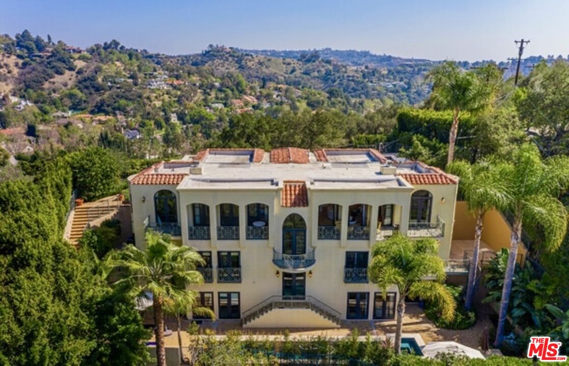 3110 Benedict Canyon Drive Beverly Hills, CA 90210 - Photo 2 of 70 a aerial view of a house with a yard and potted plants