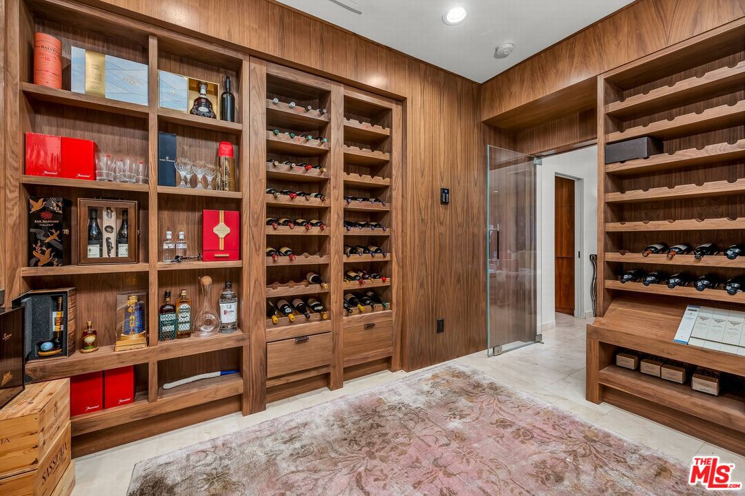 3110 Benedict Canyon Drive Beverly Hills, CA 90210 - Photo 29 of 70 a view of walk in closet with clothes and shoes
