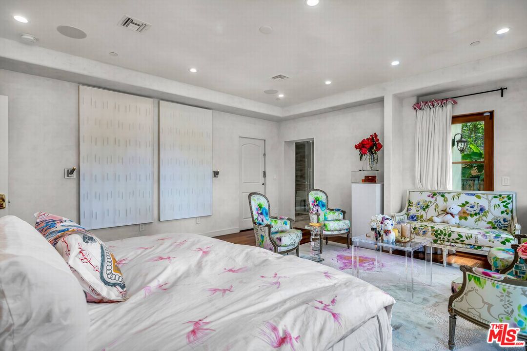 3110 Benedict Canyon Drive Beverly Hills, CA 90210 - Photo 47 of 70 a bedroom with bed and a chandelier