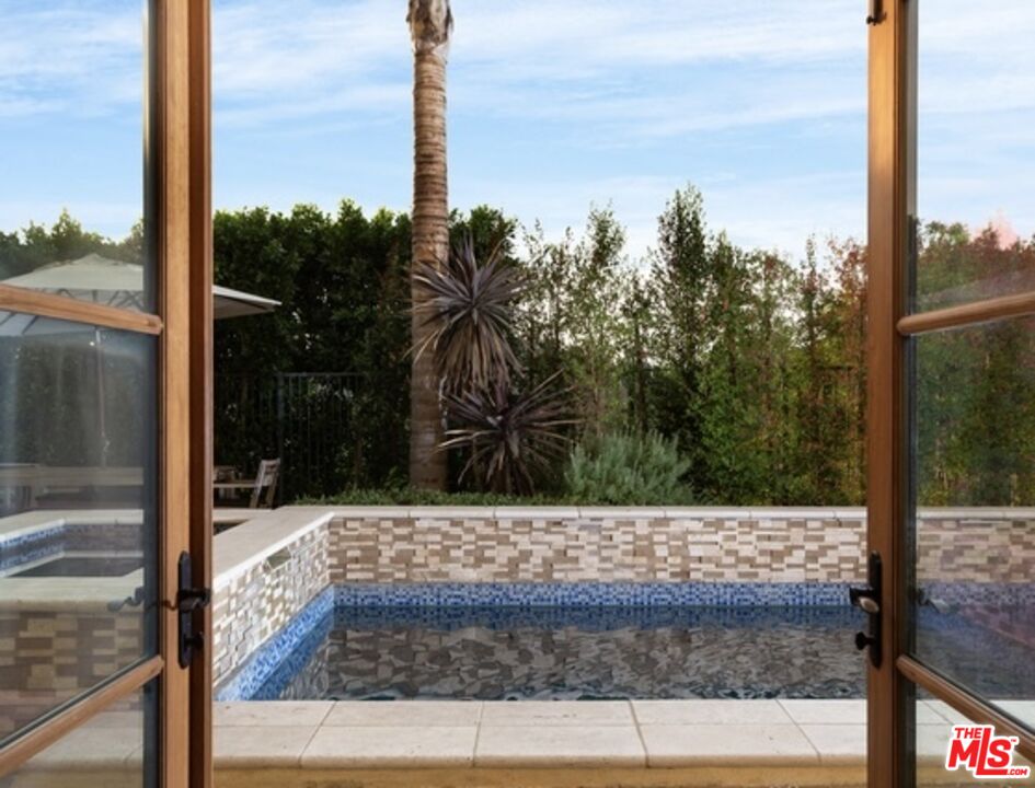 3110 Benedict Canyon Drive Beverly Hills, CA 90210 - Photo 65 of 70 a view of a glass door of the house