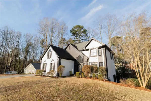 a view of a house with a yard and garage