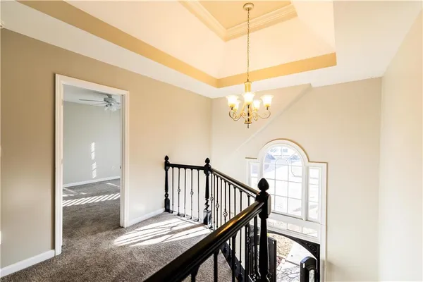 a kitchen with stainless steel appliances a large counter top a sink a refrigerator and windows