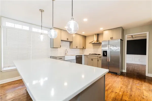 a view of an empty room with a fireplace and a window