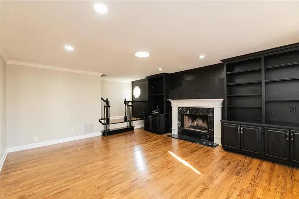 an empty room with closet and windows