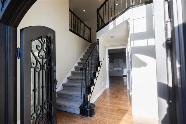 a view of a hallway with wooden floor and closet area