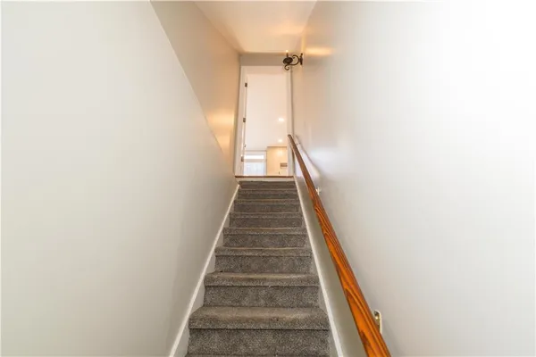 a view of a white house with a yard covered in snow